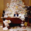 Office worker with mound of paperwork