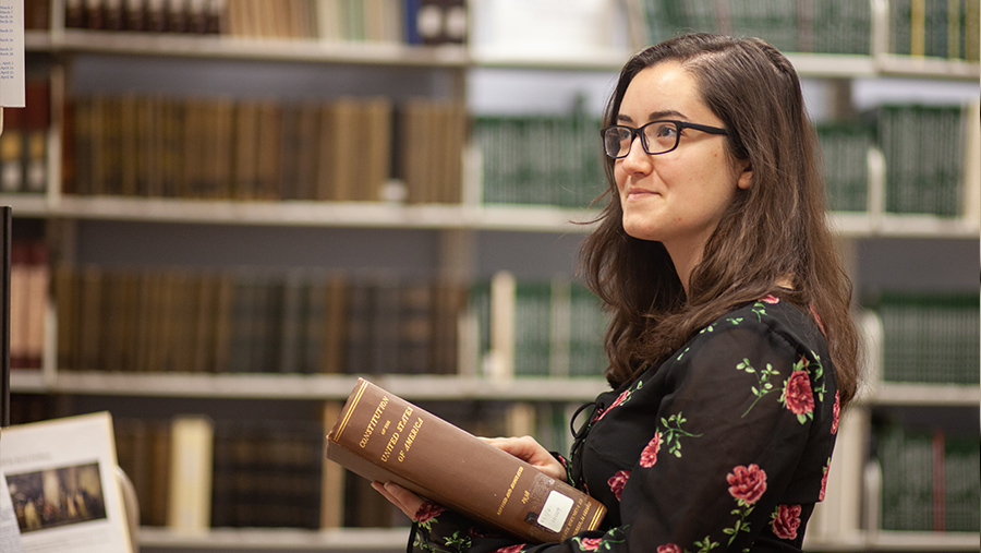 student holding book