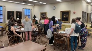 Students gathered around tables in Special Collections reviewing materials.