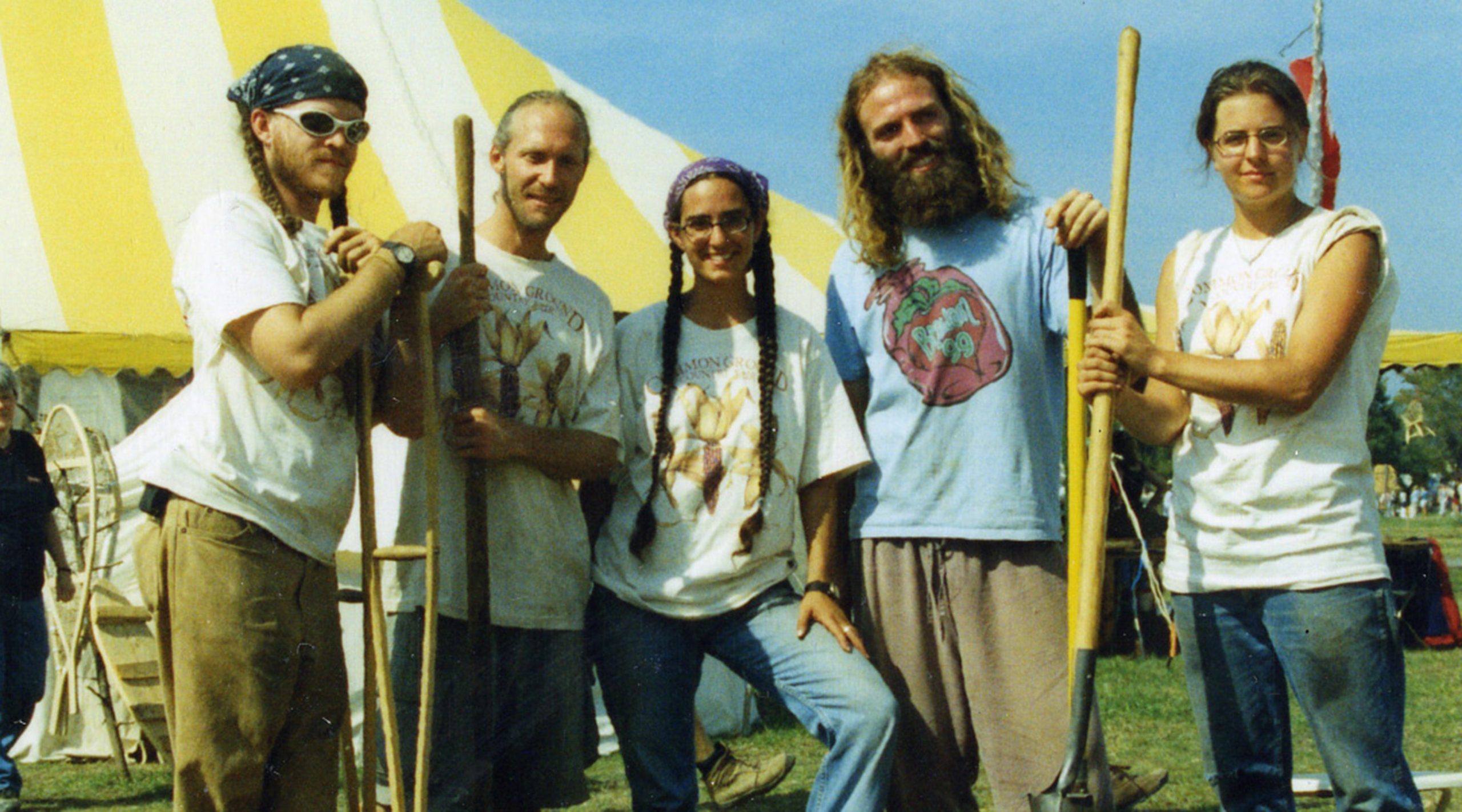 Five people in front of a tent at the Common Ground Fair in Unity, Maine