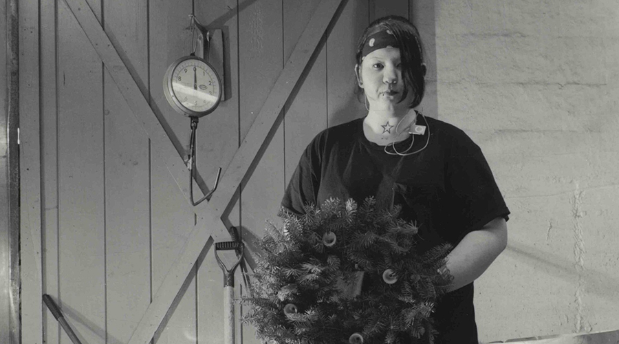 A woman holding a wreath